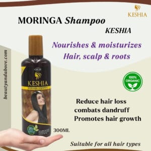 keshia-moringa-shampoo-300ml-kuwait | beauty & above An advertisement for KESHIA MORINGA SHAMPOO (300ML) showing the product bottle held by a hand. Text states "Nourishes & moisturizes Hair, scalp & roots", "Reduce hair loss, combats dandruff, promotes hair growth," and "100% Organic".